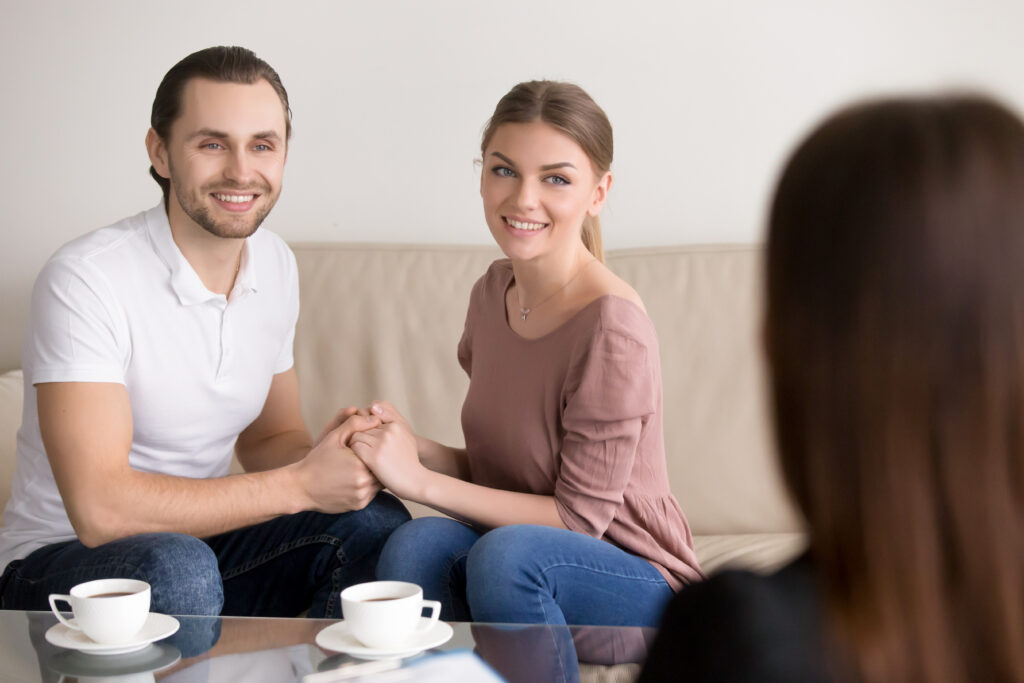 Happy young couple hold each other’s hands