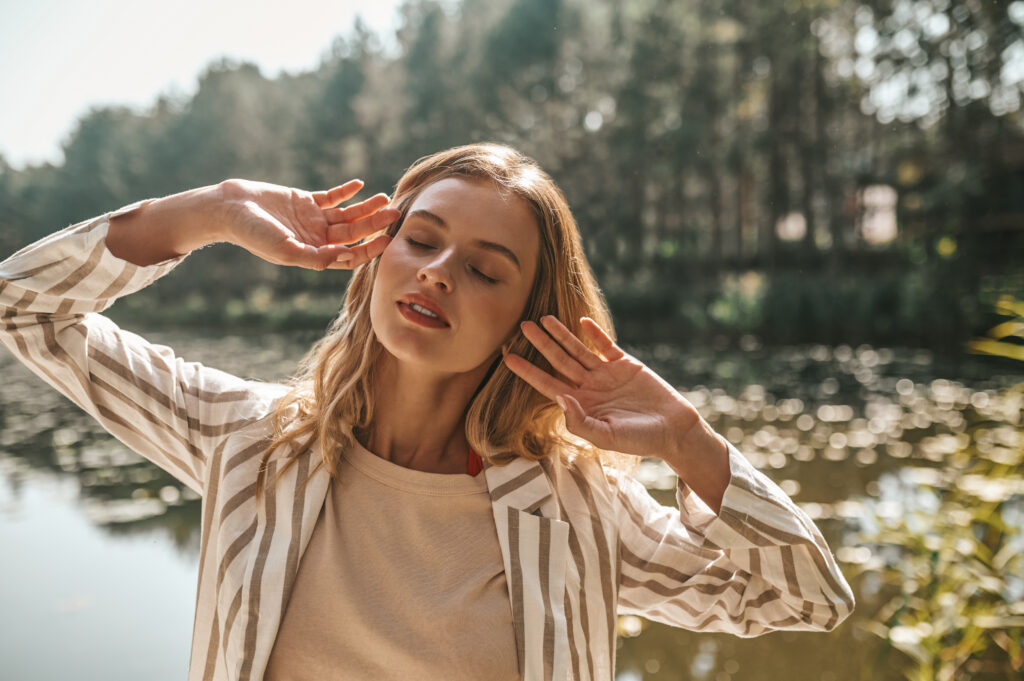 Young woman spending a day in the park near the water